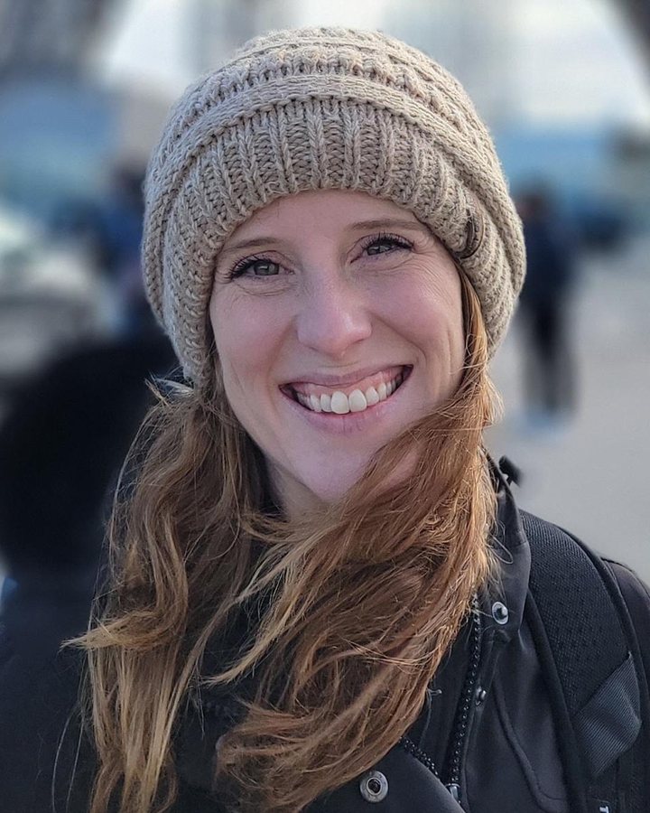 Nicole, smiling, wearing a knit hat